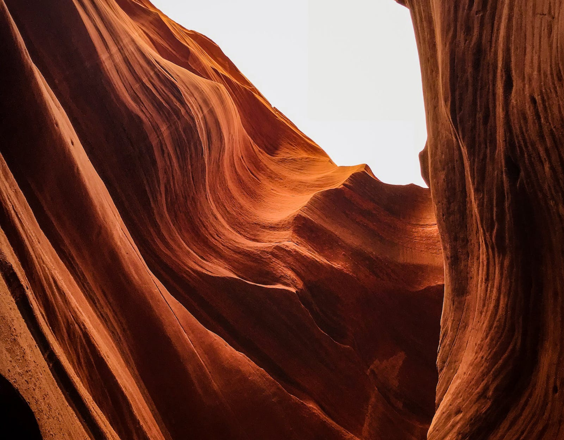 Red sandstone slot canyon, eroded walls and light.